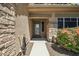 Inviting front entrance with stone accents and tasteful landscaping at 9570 W Quail Track Dr, Peoria, AZ 85383