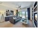Comfortable living room with a black leather sofa, an outdoor view, and modern decor at 9570 W Quail Track Dr, Peoria, AZ 85383