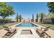 Charming pool area with a fire pit and Adirondack chairs, perfect for relaxing outdoors in style at 9570 W Quail Track Dr, Peoria, AZ 85383