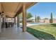 Inviting covered patio and pool area perfect for entertaining outdoors with lush green grass at 9570 W Quail Track Dr, Peoria, AZ 85383