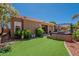 Expansive backyard with outdoor kitchen, pergola, and pristine artificial turf at 9642 E Irwin Ave, Mesa, AZ 85209