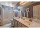 Bathroom features double sink vanity, large mirror, tub, and white tile surround at 9642 E Irwin Ave, Mesa, AZ 85209