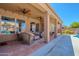 Relaxing covered patio with comfortable seating, ceiling fans, and views of the backyard at 9642 E Irwin Ave, Mesa, AZ 85209