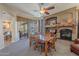 Dining area showcasing stylish furniture, a cozy fireplace, and seamless connectivity to outdoor space at 9642 E Irwin Ave, Mesa, AZ 85209