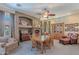 Cozy dining room with a fireplace, wooden dining table, comfortable seating, and an elegant display cabinet at 9642 E Irwin Ave, Mesa, AZ 85209