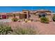 Charming single-story home with a well-manicured front yard, desert landscaping, and a tile roof at 9642 E Irwin Ave, Mesa, AZ 85209