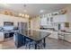 Bright kitchen features stainless steel appliances, tiled floors, white cabinetry, and a center island with bar seating at 9642 E Irwin Ave, Mesa, AZ 85209