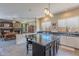 Open concept kitchen with an island, granite counters, white cabinets, and adjacent dining area at 9642 E Irwin Ave, Mesa, AZ 85209
