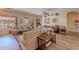 Open-concept living room with wood-look floors, large windows, and comfortable seating area at 9642 E Irwin Ave, Mesa, AZ 85209