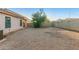 Spacious backyard with gravel landscaping and block wall fencing, offering privacy and low maintenance at 9704 W Cordes Rd, Tolleson, AZ 85353