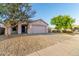 Attractive home with low maintenance desert landscaping, driveway, and inviting front entrance at 9704 W Cordes Rd, Tolleson, AZ 85353