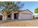 Charming single-story home with a well-maintained front yard, two car garage and tiled roof at 9704 W Cordes Rd, Tolleson, AZ 85353