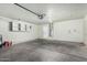 Spacious garage with ample storage and a door to the house showcases functional design at 9704 W Cordes Rd, Tolleson, AZ 85353