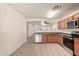 Bright eat-in kitchen with stainless steel appliances and an open view to the living room at 9704 W Cordes Rd, Tolleson, AZ 85353