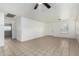 Open living room features tile flooring and plenty of natural light from a large window at 9704 W Cordes Rd, Tolleson, AZ 85353