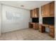 Office space featuring built-in desk with cabinets and drawers, offering ample storage at 9704 W Cordes Rd, Tolleson, AZ 85353