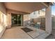 Covered patio with tile flooring features a dining set and sliding glass doors leading inside at 9704 W Cordes Rd, Tolleson, AZ 85353