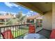 Balcony overlooking lush green landscaping and community buildings with seating at 9711 E Mountain View Rd # 2543, Scottsdale, AZ 85258