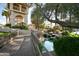 Charming community entrance with waterfall features, rock landscaping, and a wooden bridge at 9711 E Mountain View Rd # 2543, Scottsdale, AZ 85258