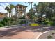 Entrance to the racquet club with well-kept landscaping and stone details at 9711 E Mountain View Rd # 2543, Scottsdale, AZ 85258