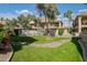 Well-maintained community grounds, featuring a pool, green grass, and native plants at 9711 E Mountain View Rd # 2543, Scottsdale, AZ 85258