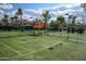 View of well-maintained community tennis courts with covered seating area at 9711 E Mountain View Rd # 2543, Scottsdale, AZ 85258