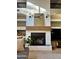 Stylish fireplace with a wooden mantel, sconces, and built-in shelving at 16016 S 7Th S St, Phoenix, AZ 85048