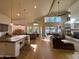 Bright open-concept living space with a kitchen island, wood floors, and a cozy seating area overlooking the pool at 16016 S 7Th S St, Phoenix, AZ 85048