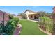 Serene backyard featuring vibrant greenery, manicured landscaping, and a covered patio at 16036 N 11Th Ave # 1084, Phoenix, AZ 85023