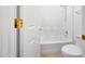 Bright white bathroom with white tub and tile surround, toilet and brushed nickel hardware at 16036 N 11Th Ave # 1084, Phoenix, AZ 85023
