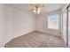 Cozy bedroom with neutral carpet, a ceiling fan, and a bright window at 16036 N 11Th Ave # 1084, Phoenix, AZ 85023