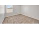 Cozy bedroom with neutral carpet, large window, and fresh white walls at 16036 N 11Th Ave # 1084, Phoenix, AZ 85023