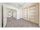 Bright bedroom featuring a ceiling fan, large window, and built-in shelves at 16036 N 11Th Ave # 1084, Phoenix, AZ 85023
