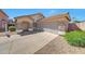 Charming home showcasing stone accents, a well-maintained yard, and an attached two-car garage at 16036 N 11Th Ave # 1084, Phoenix, AZ 85023