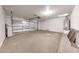 Clean two car garage featuring concrete flooring, white walls, and insulated garage door at 16036 N 11Th Ave # 1084, Phoenix, AZ 85023