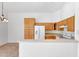 Bright kitchen featuring oak cabinets, white appliances, and a functional layout for cooking and entertaining at 16036 N 11Th Ave # 1084, Phoenix, AZ 85023
