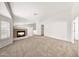 Bright living room with a cozy fireplace and neutral carpet, offering a welcoming space at 16036 N 11Th Ave # 1084, Phoenix, AZ 85023