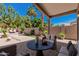 Backyard patio with a seating area, lush landscaping, and desert views at 1712 E Saratoga St, Gilbert, AZ 85296