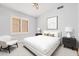Cozy bedroom with a white bed, accent chair, and contemporary decor at 1712 E Saratoga St, Gilbert, AZ 85296