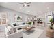 Spacious living room featuring modern decor, an open floor plan, and a ceiling fan at 1712 E Saratoga St, Gilbert, AZ 85296