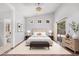 Bright main bedroom with a tray ceiling, large window, and stylish decor at 1712 E Saratoga St, Gilbert, AZ 85296