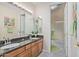 Bright bathroom featuring double sinks, granite countertops, and a shower over tub at 1779 E Kaibab Dr, Chandler, AZ 85249