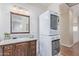 Bathroom features vanity, granite countertops, stacked washer and dryer, and decorative bowl at 1779 E Kaibab Dr, Chandler, AZ 85249