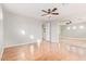 Spacious bedroom with wood floors, ceiling fan, mirrored closet doors, and natural light at 1779 E Kaibab Dr, Chandler, AZ 85249