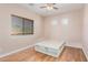 Bedroom showcasing hardwood floors, natural light from the windows, and a custom bed frame at 1779 E Kaibab Dr, Chandler, AZ 85249