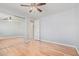 This bedroom features a ceiling fan, closet with mirrors, and gorgeous wood floors at 1779 E Kaibab Dr, Chandler, AZ 85249