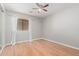 Cozy bedroom featuring hardwood floors, a ceiling fan, and natural light from the window at 1779 E Kaibab Dr, Chandler, AZ 85249