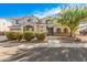 Charming two-story home with neutral stucco, stone accents, groomed bushes and mature tree at 1779 E Kaibab Dr, Chandler, AZ 85249