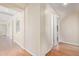 Hallway with wood floors, neutral walls, arched decor, and open doors at 1779 E Kaibab Dr, Chandler, AZ 85249