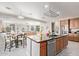 A kitchen island, appliances, dining area, and part of the living room fill this open-concept layout at 1779 E Kaibab Dr, Chandler, AZ 85249